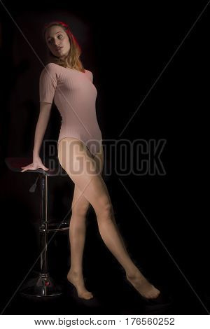 Young girl with pink body isolated on black background