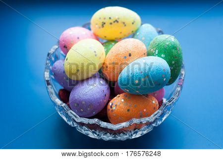 Easter Eggs In A Crystal Dish On A Blue Background,