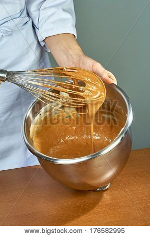 chef whips yellow cream in a bowl by hand for making cheesecakes complete series of food recipes