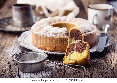 Marble cake.Easter Cake. Marble cake cup of coffee powder sugar and kitchen vintage utensil.