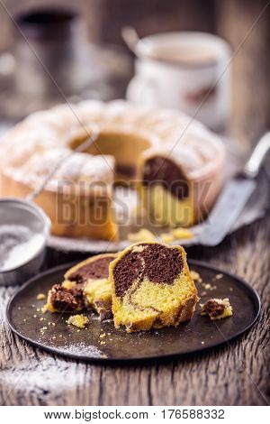 Marble cake.Easter Cake. Marble cake cup of coffee powder sugar and kitchen vintage utensil.