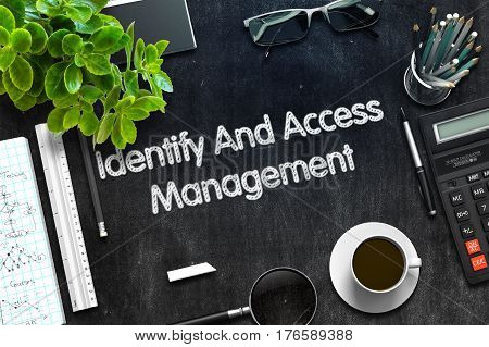 Business Concept - Identify And Access Management Handwritten on Black Chalkboard. Top View Composition with Chalkboard and Office Supplies on Office Desk. 3d Rendering. Toned Illustration.