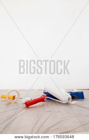 Roller, Paint And Paint Tray On Cover Sheeting, White Background