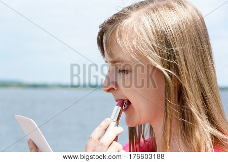 European blond woman looking in the mirror