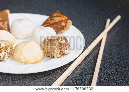 Delicious Assortment Of Homemade Asian Pastries. Samosas With A Rose Flower And Banana Balls