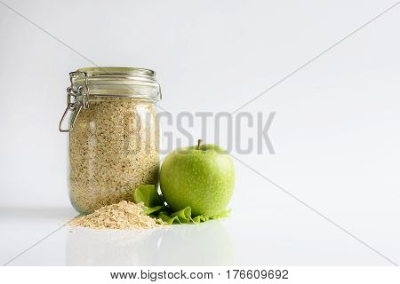 oatmeal and green apple on white background