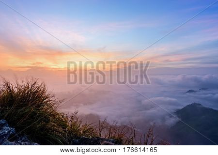 Beautiful landscape nature sunrise on peak mountain with sun cloud fog and bright colors of sky in winter at Phu Chi Fa Forest Park is a famous tourist attraction of Chiang Rai Province Thailand