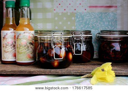 LACOCK, UK - MARCH 11, 2017: Homemade juice, pickles and jam for sale in small village of Lacock, England. Buyer are asked to pay for products into honesty box.