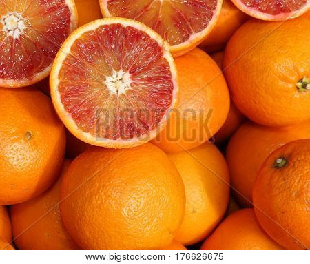 Ripe Oranges And An Orange Cut In The Stall Of Greengrocer