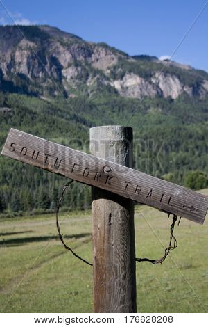 Wooden hiking trail sign for South Forth Trail in Colorado mountains.