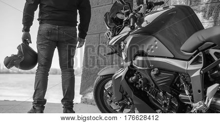 Senta Serbia: March 4th 2017. Driver with helmet, standing besides his bike. Power of dreams. Dock of the river Tisa in Senta.