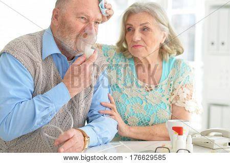 Portrait of an elderly senior couple with oxygen mask