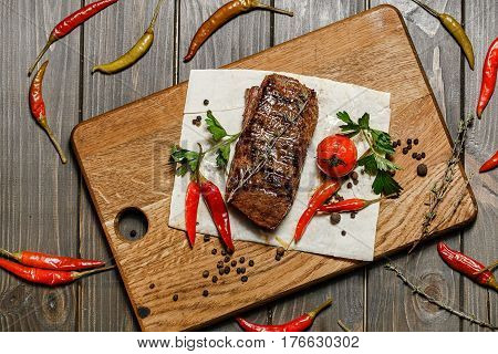 delicious grilled meat with vegetables on a wooden board