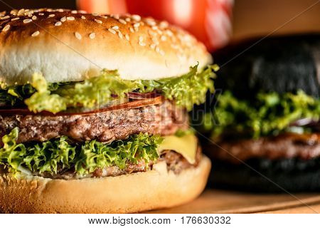 tasty burgers on wooden board close up