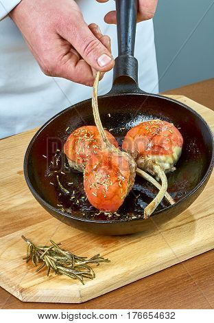 Cook stuffed eggplant process of cooking is preparing a garnish for lamb ribs