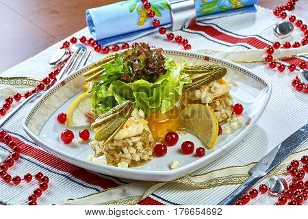 Jellied chicken with mushrooms pickled cucumber lettuce restaurant menu Chicken with mushrooms pickled cucumber lettuce restaurant menu on tablecloth fresh berries ornaments