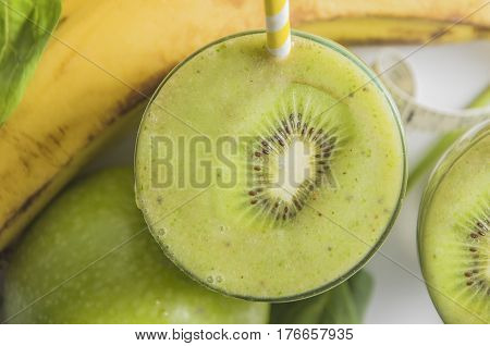 Fresh and healthy green smoothie with spinach,banana, kiwi and apple. Selective focus