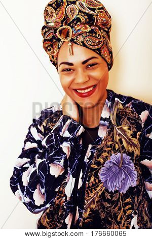 beauty bright african woman with creative make up, shawl on head like cubian closeup smiling, cheerful tan , lifestyle people concept close up