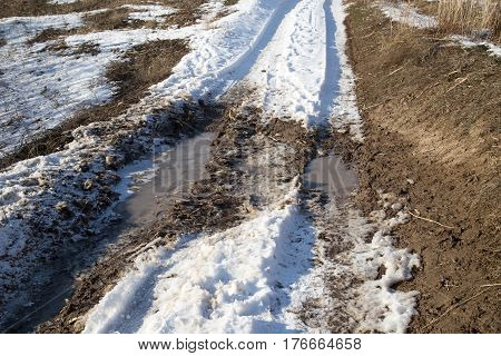 traces of the car in the snow in winter .