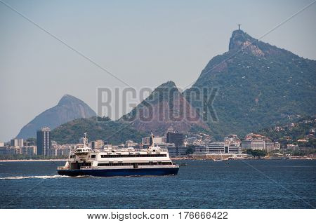Rio de Janeiro, Brazil - February 11, 2017: Ferry boat crossing Guanabara bay with Corcovado in background. erries are useful mode of transport for getting between Rio de Janeiro and Niteroi.