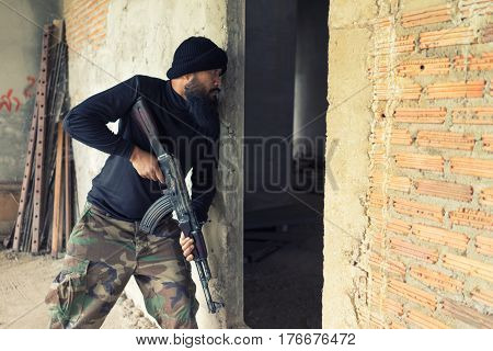 Terrorist In Black Uniform And Mask With Kalashnikov