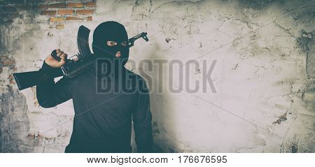 Terrorist In Black Uniform And Mask With Kalashnikov