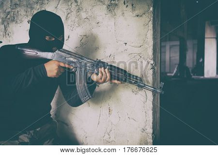 Terrorist In Black Uniform And Mask With Kalashnikov