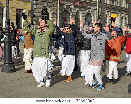 12.03.2017.Russia.Saint-Petersburg.On the street gathered followers of Lord Krishna.Young people are dancingcollecting alms and distributing sweets.