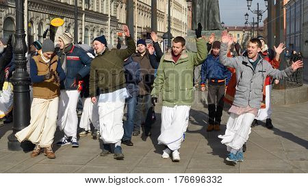 12.03.2017.Russia.Saint-Petersburg.On the street gathered followers of Lord Krishna.Young people are dancingcollecting alms and distributing sweets.
