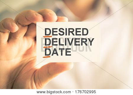 Businessman Holding Card With Ddd Desired Delivery Date Acronym Text