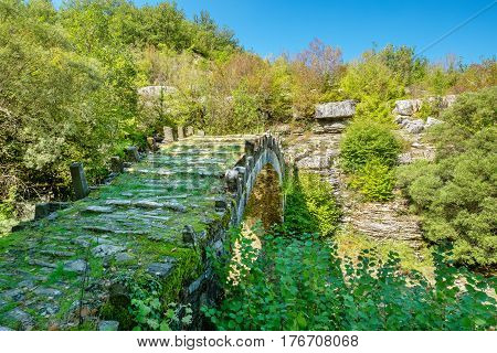 One-arch stone bridge of Captain Arkouda on the river of Xiropotamos. Central Zagori. Epirus Greece