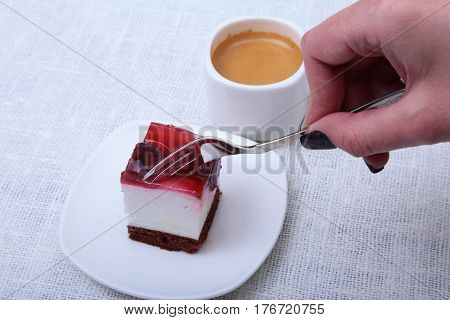 Slice of handmade cherry pie on a plate and classic espresso coffee in white background.