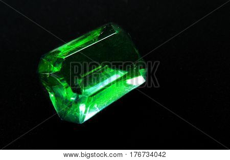 green emerald gem crystal precious jewel on black background