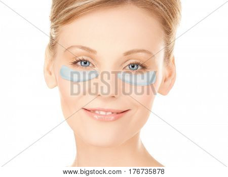 beauty, cosmetology, hydration, people and rejuvenation concept - close up of beautiful young woman face with hydrogel under-eye patches over white background