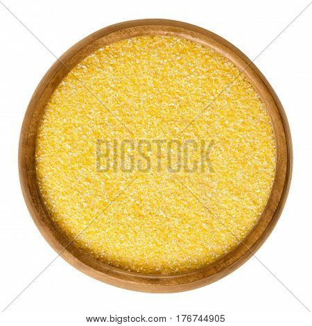 Cornmeal in wooden bowl. Raw uncooked meal, medium ground from dried maize. Common stable food. Boiled cornmeal is called polenta. Isolated macro food photo close up from above on white background.