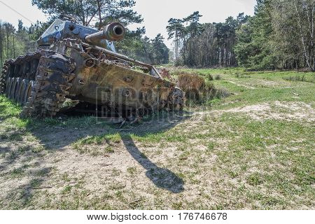 Battle tank in the moor of a forest