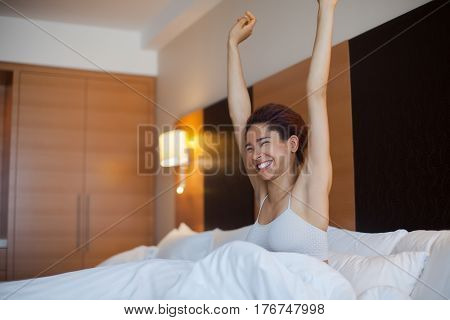 Young Happy Black Woman Sits In A Bed.