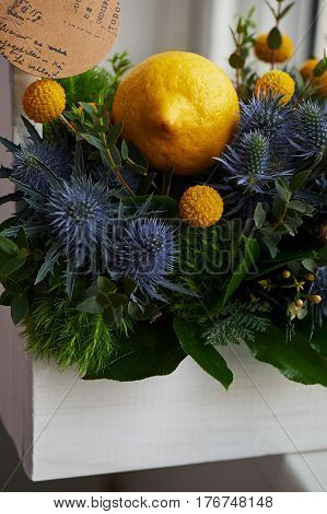 A spring bouquet in a white wooden box in the yellow-green spectrum. lemon.