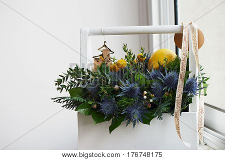 A spring bouquet in a white wooden box in the yellow-green spectrum. lemon.
