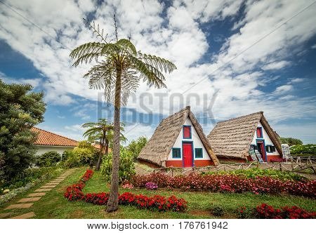 Old traditional Madeira huts with characteristic traingle thatched roofs in Santana madeira. There is Touristic Information in one of the buildings.