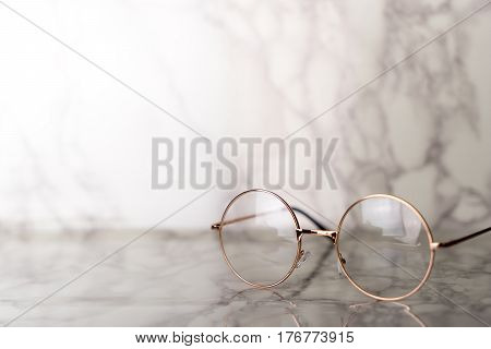 Vintage golden Eyeglasses on luxury marble stone table