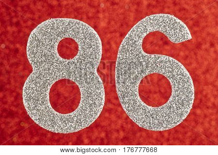 Number eighty-six silver color over a red background. Anniversary. Horizontal