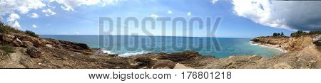 Panoramic of Cupecoy in St. Martin/St. Maarten showing the interesting geological rock formations with Caribbean sea and interesting sky.