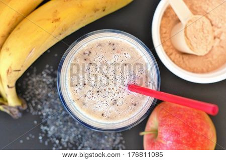 Healthy Fresh Smoothie Drink From Red Apple, Banana Chia Seeds And Plant Protein Powder In The Glass