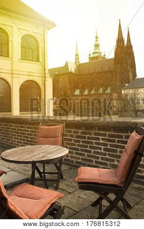 chairs and wooden table on the terrace sunny hot day in Europe