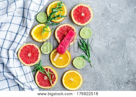 fruit design with cut blood orange and lime on gray stone table background top view mock-up