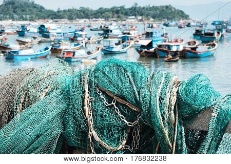 Fishing net in the harbor. Green fishing net.Sea and Boats on background
