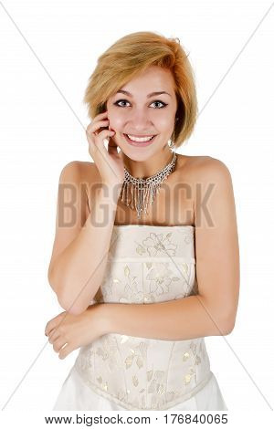 Happy girl in a white evening dress and necklace. Bare shoulders. Isolated on white background