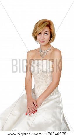 Happy girl in a white evening dress and necklace. Bare shoulders. Butch. Isolated on white background