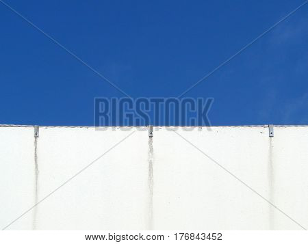 emty white wall and clear blue sky